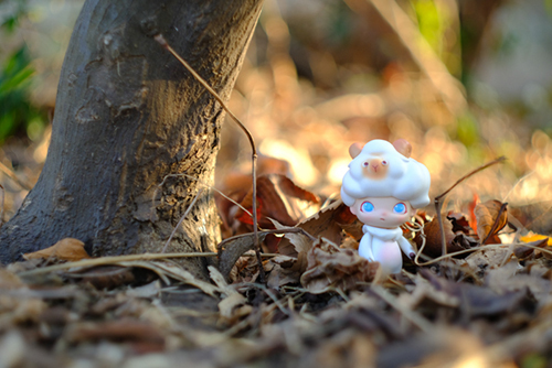 ツバキアキラが撮った、POPMART・DIMOO・はぐれ動物シリーズ。枯れ葉の中に佇む、ヒツジさん。